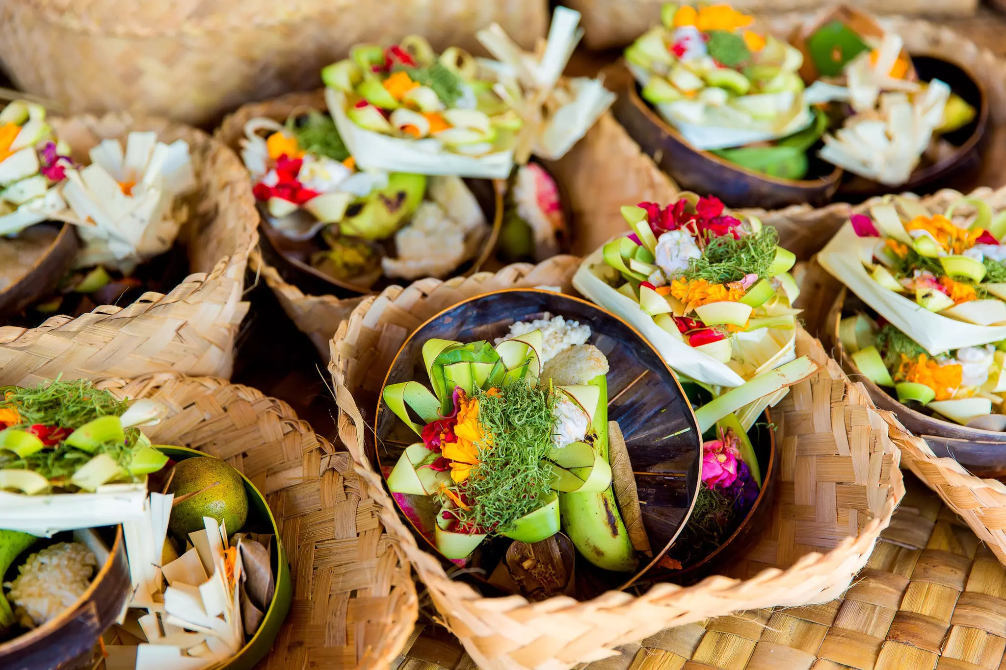 Traditional Balinese offerings to gods with flowers and aromatic sticks.