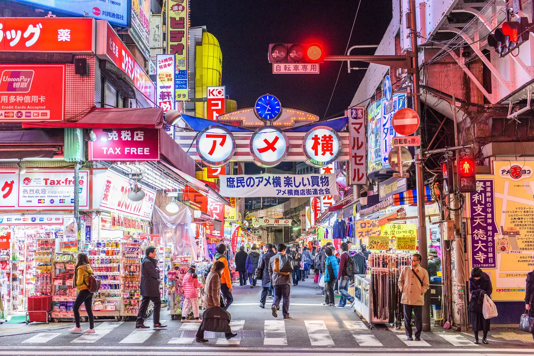 TOKYO - DECEMBER 31:  A fishmonger sells seafood at a fish stall in the Ameya Yokocho street market on December 31, 2008 in Tokyo, Japan. People shop around in preparation to celebrate the New Year holidays at the market featuring over 500 stalls,...