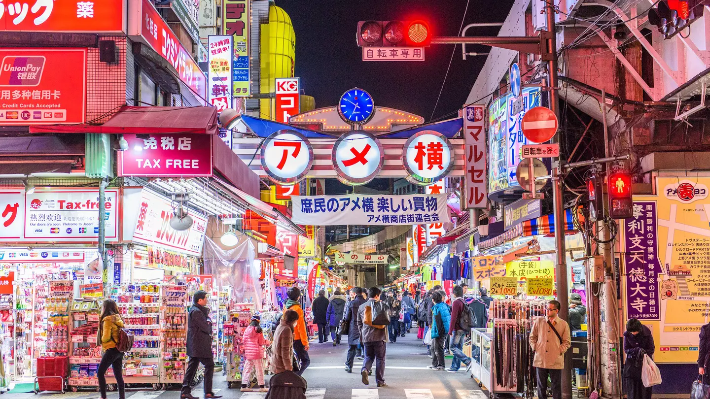 TOKYO - DECEMBER 31:  A fishmonger sells seafood at a fish stall in the Ameya Yokocho street market on December 31, 2008 in Tokyo, Japan. People shop around in preparation to celebrate the New Year holidays at the market featuring over 500 stalls,...