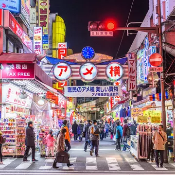 TOKYO - DECEMBER 31:  A fishmonger sells seafood at a fish stall in the Ameya Yokocho street market on December 31, 2008 in Tokyo, Japan. People shop around in preparation to celebrate the New Year holidays at the market featuring over 500 stalls,...