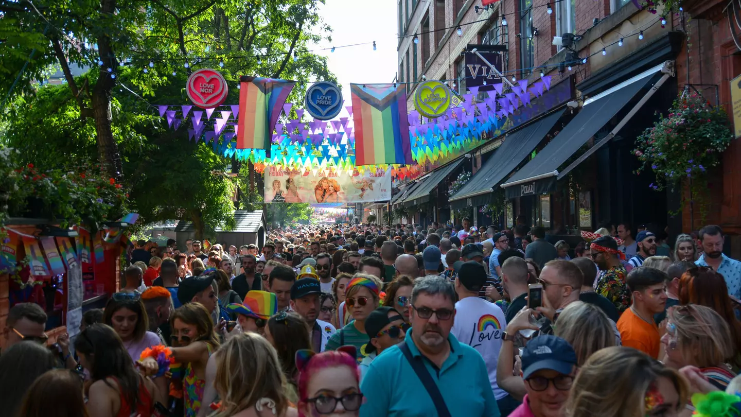 People celebrate during Manchester Pride, one of the UK's largest Gay Pride events including a parade and live music events throughout bank holiday weekend in August.