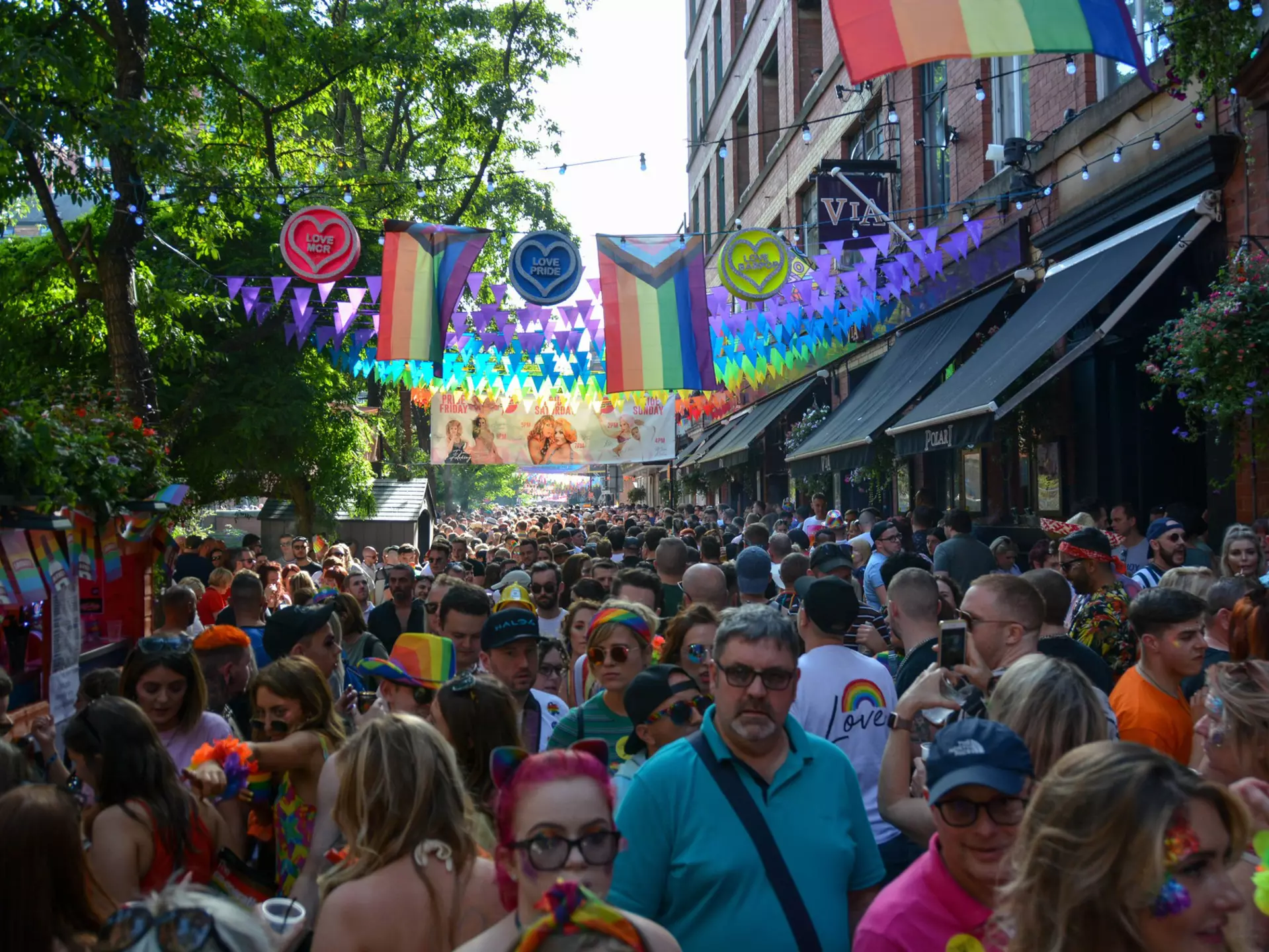 People celebrate during Manchester Pride, one of the UK's largest Gay Pride events including a parade and live music events throughout bank holiday weekend in August.