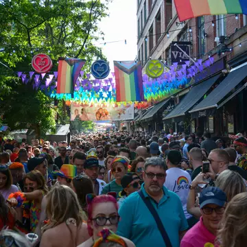 People celebrate during Manchester Pride, one of the UK's largest Gay Pride events including a parade and live music events throughout bank holiday weekend in August.