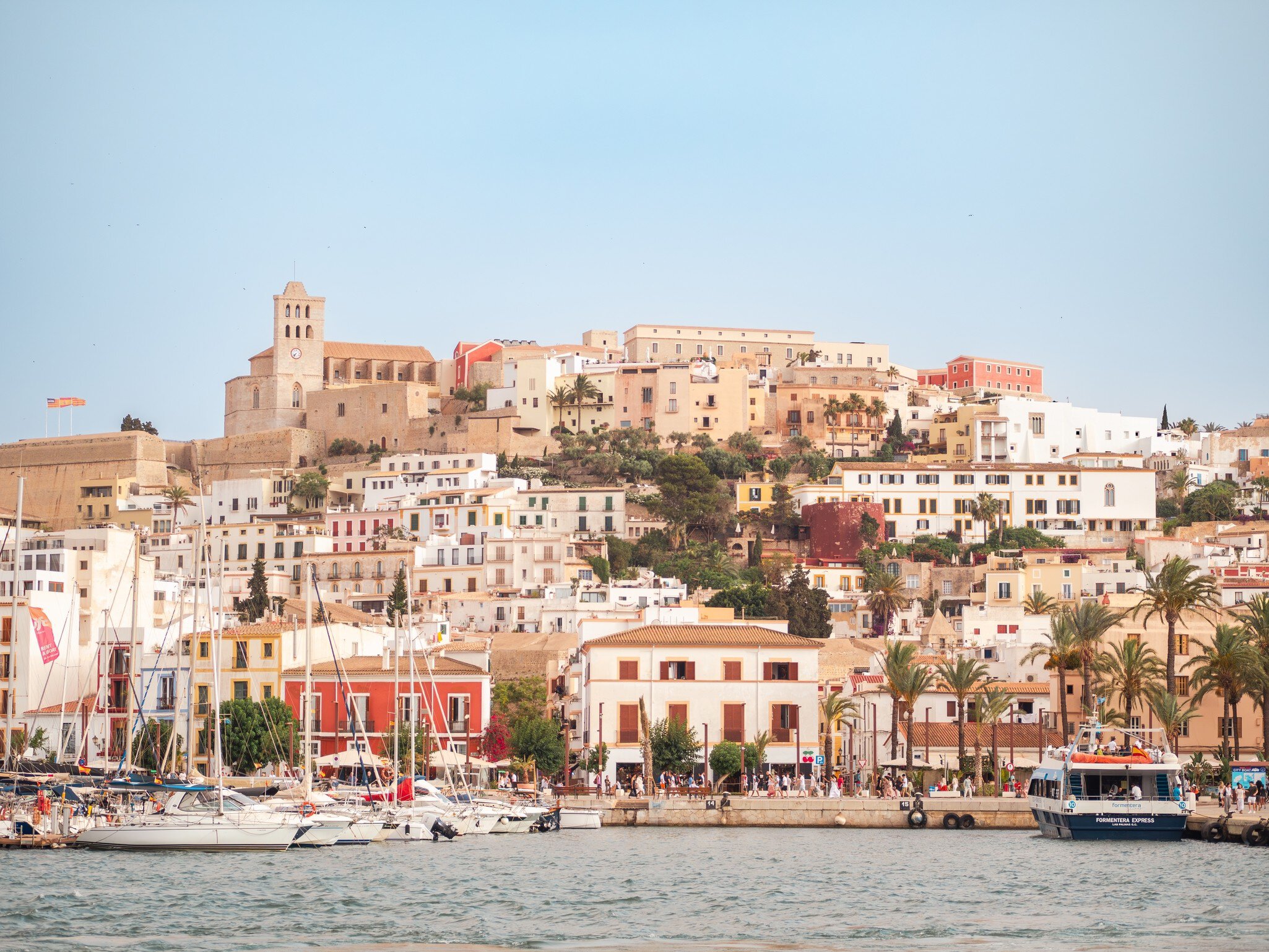 View of Ibiza Town and its harbor promenade from the water in Spain.