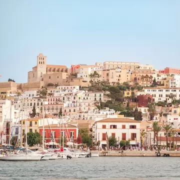 View of Ibiza Town and its harbor promenade from the water in Spain.