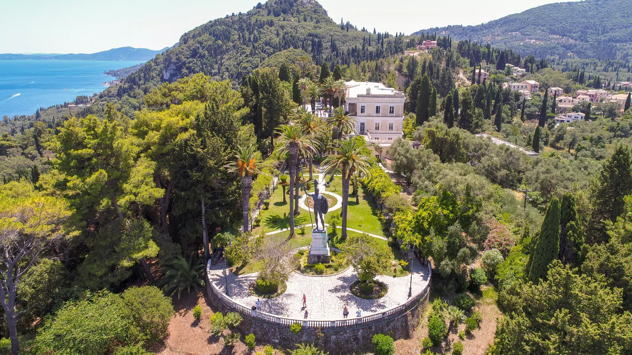 Aerial view of a Greek palace surrounded by lush greenery
