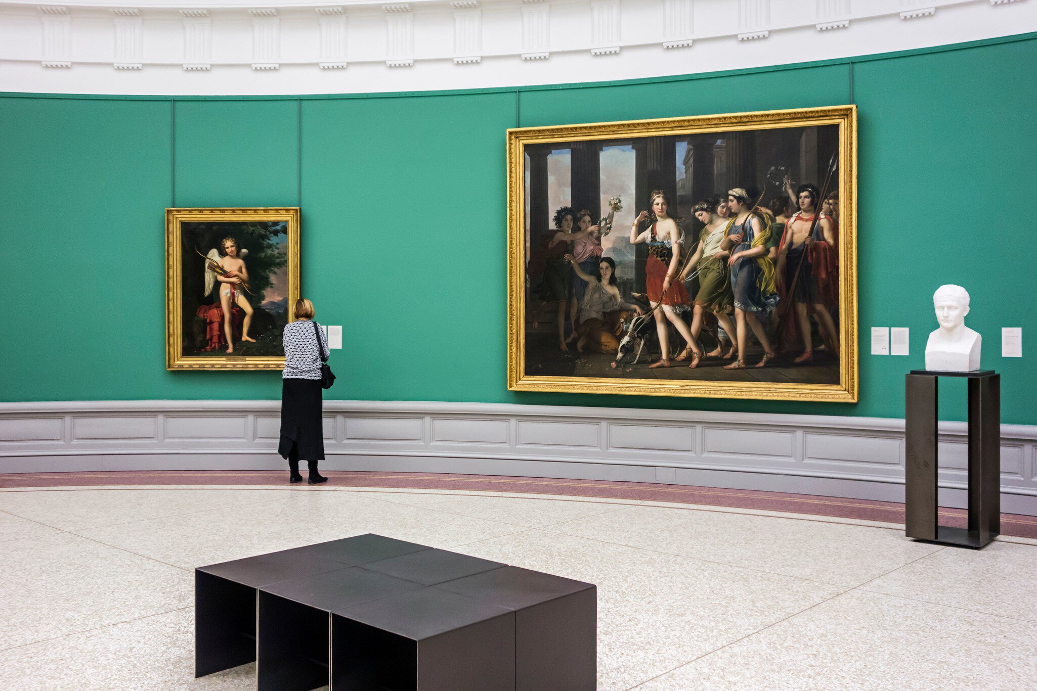 Woman looking at sculpture and old paintings in the Museum of Fine Arts / Museum voor Schone Kunsten / MSK in Ghent, Belgium