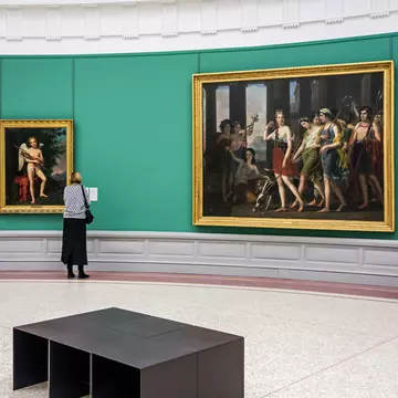 Woman looking at sculpture and old paintings in the Museum of Fine Arts / Museum voor Schone Kunsten / MSK in Ghent, Belgium