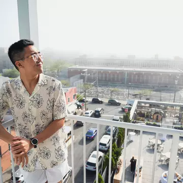 Chris Dong on his hotel room's balcony, Rockaway Hotel