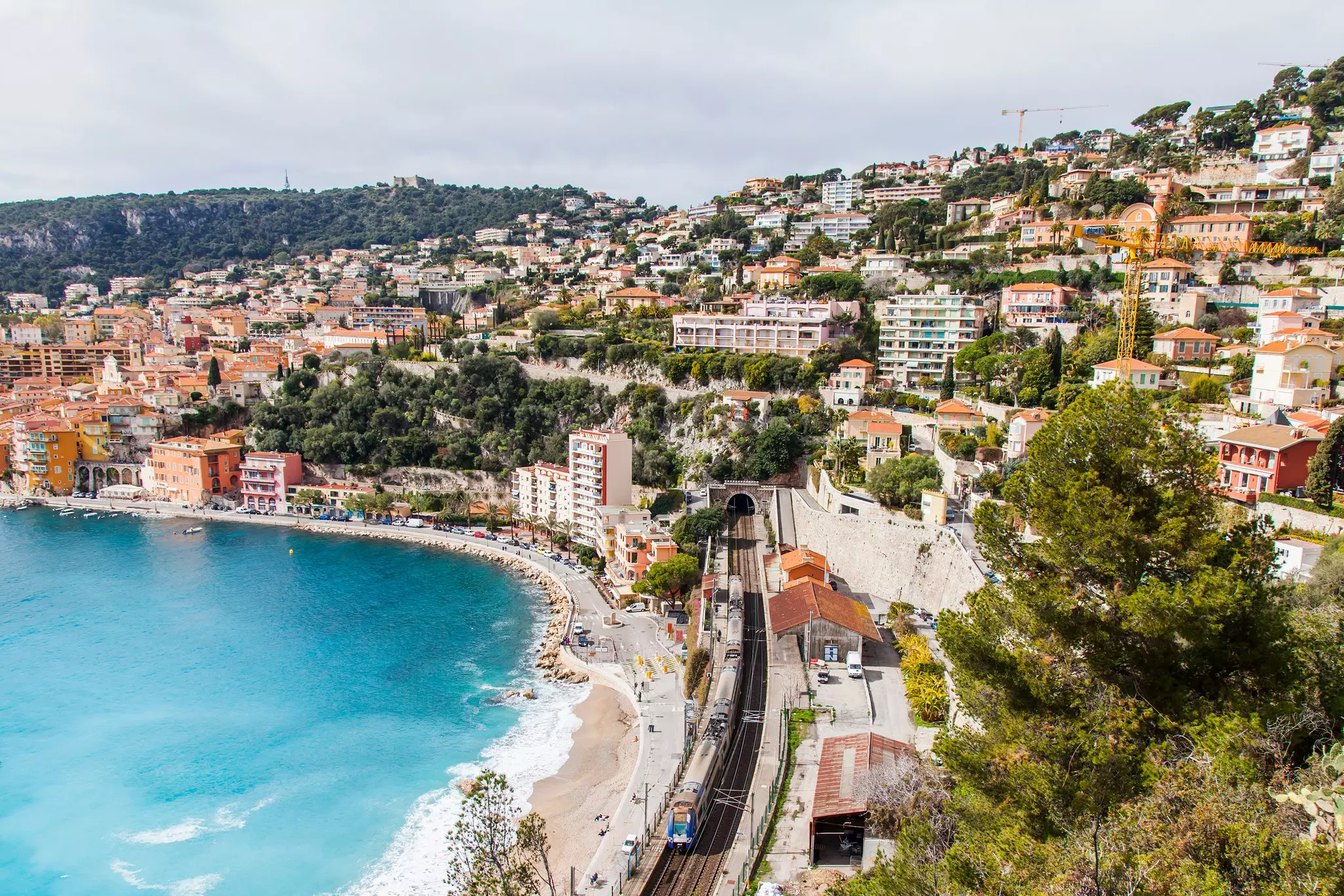 A view of the picturesque bay in Villefranche-sur-Mer, the embankment and the railroad passing across the seashore