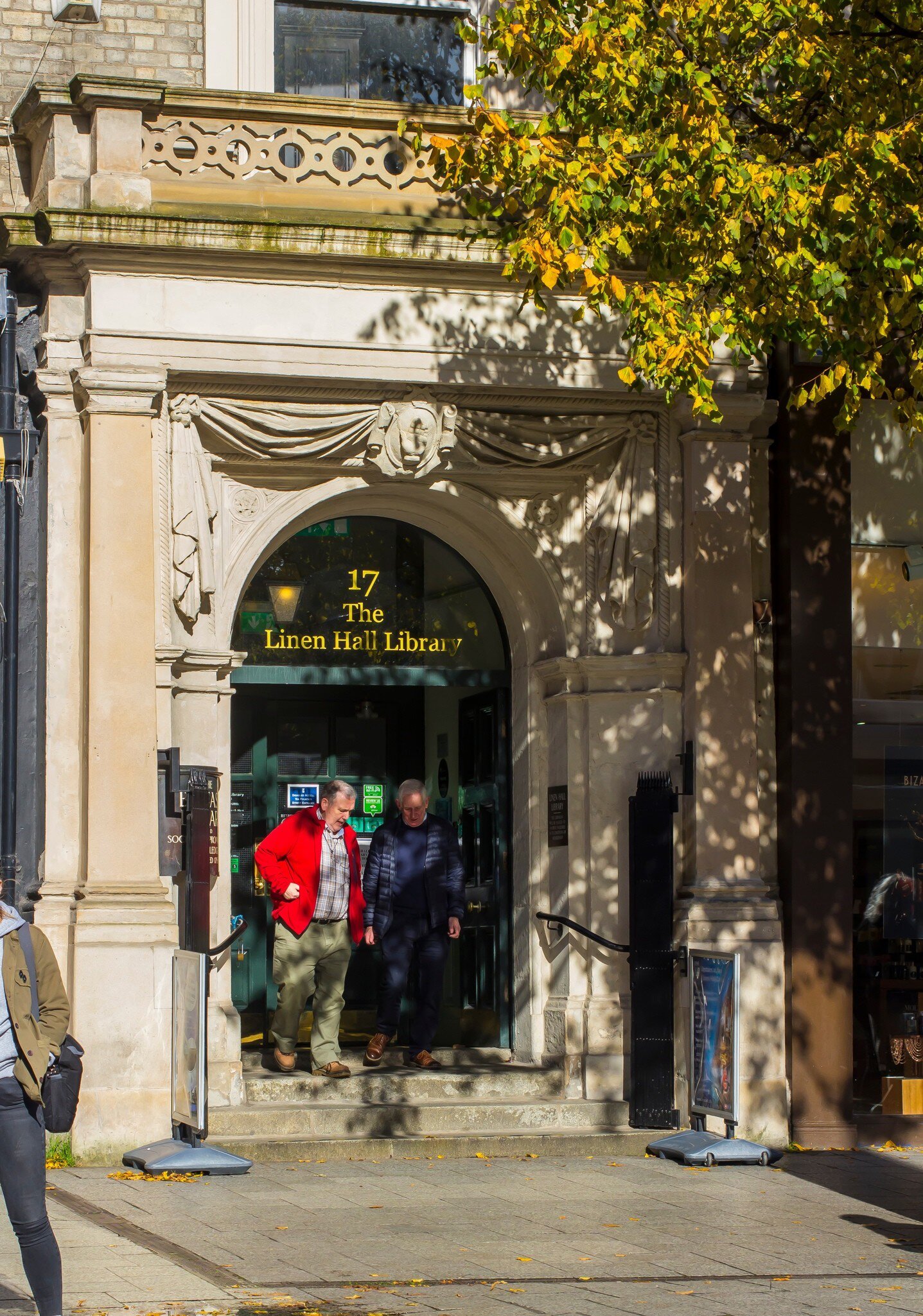 A couple of elderly gentlemen at the entrance of Belfast's Linen Hall Library in Donegall Square North Belfast. This famous library is a centre of cultural heritage in Northern Ireland.