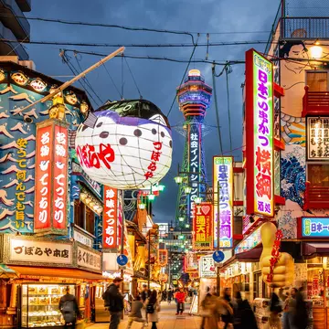 Crowded Shinsekai District, Tsutenkaku Tower in the background. Illuminated Neon Billboards at Night, Vibrant Osaka Shinsekai Cityscape. Shinsekai, Osaka, Japan, Asia