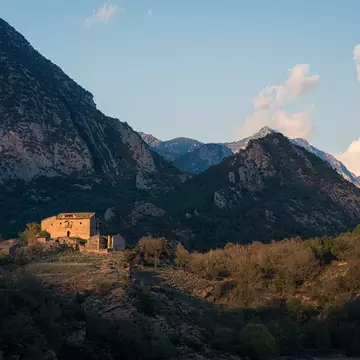 Farmhouse in mountains.