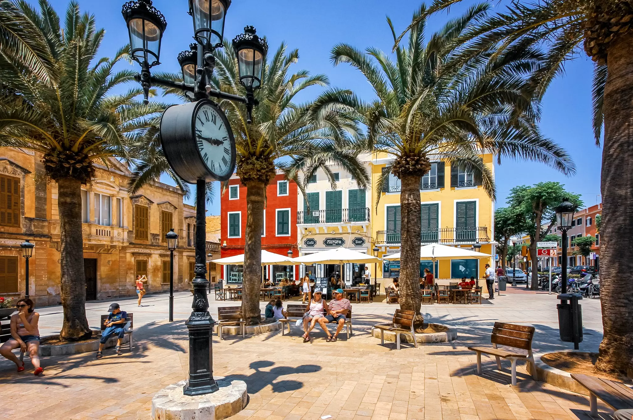 People relaxing on Plaza de Alfonso III in the center of Ciutadella, Menorca. BigDane/Shutterstock