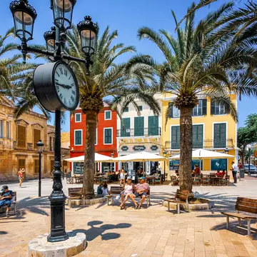 People relaxing on Plaza de Alfonso III in the center of Ciutadella, Menorca. BigDane/Shutterstock