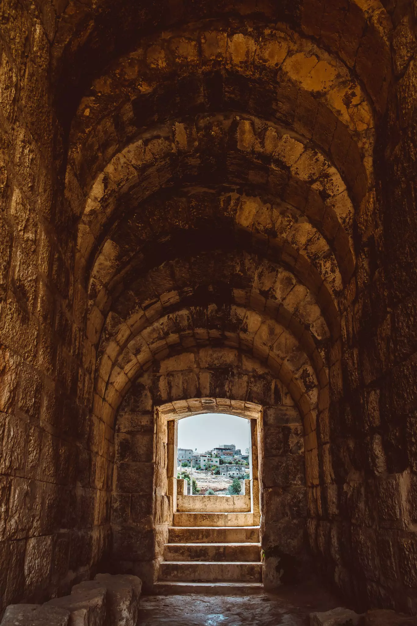 A view of a modern city through a doorway for ancient architecture