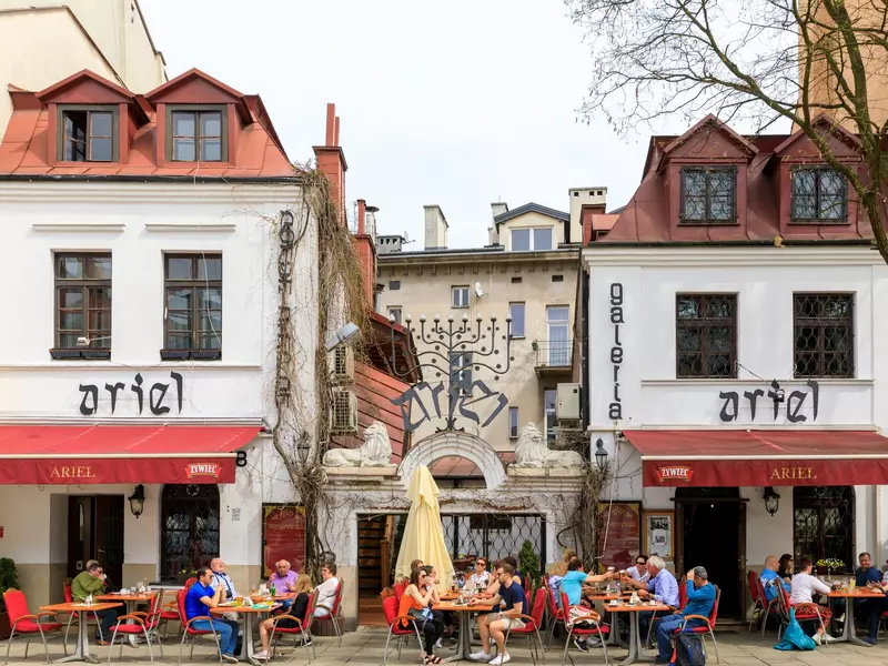 whit buildings with red roofs and a tan building behind