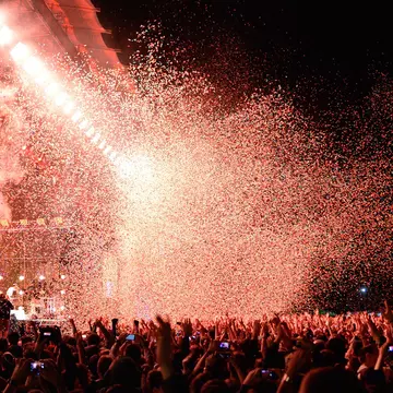 BARCELONA - MAY 29: Crowd watch a concert by the famous band Arcade Fire, while throwing confetti from the stage at Heineken Primavera Sound 2014 Festival on May 29, 2014 in Barcelona, Spain.  License Type: media  Download Time: 2023-07-19T11:09:17.000Z  User: ceri_lp  Is Editorial: Yes  purchase_order:   