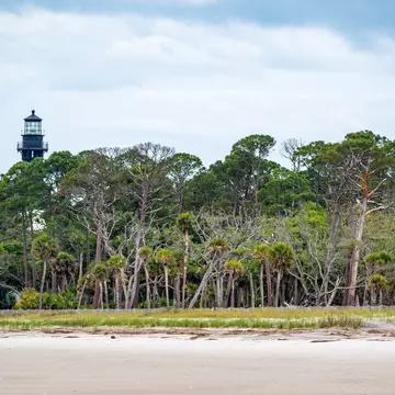 Hunting Island, South Carolina  United States - April 19, 2022: Moody cloudy sky over beach and lighthouse,  Hunting Island State Park; Shutterstock ID 2174327595;