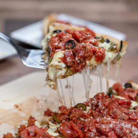 Close up of Chicago style deep dish pizza being served