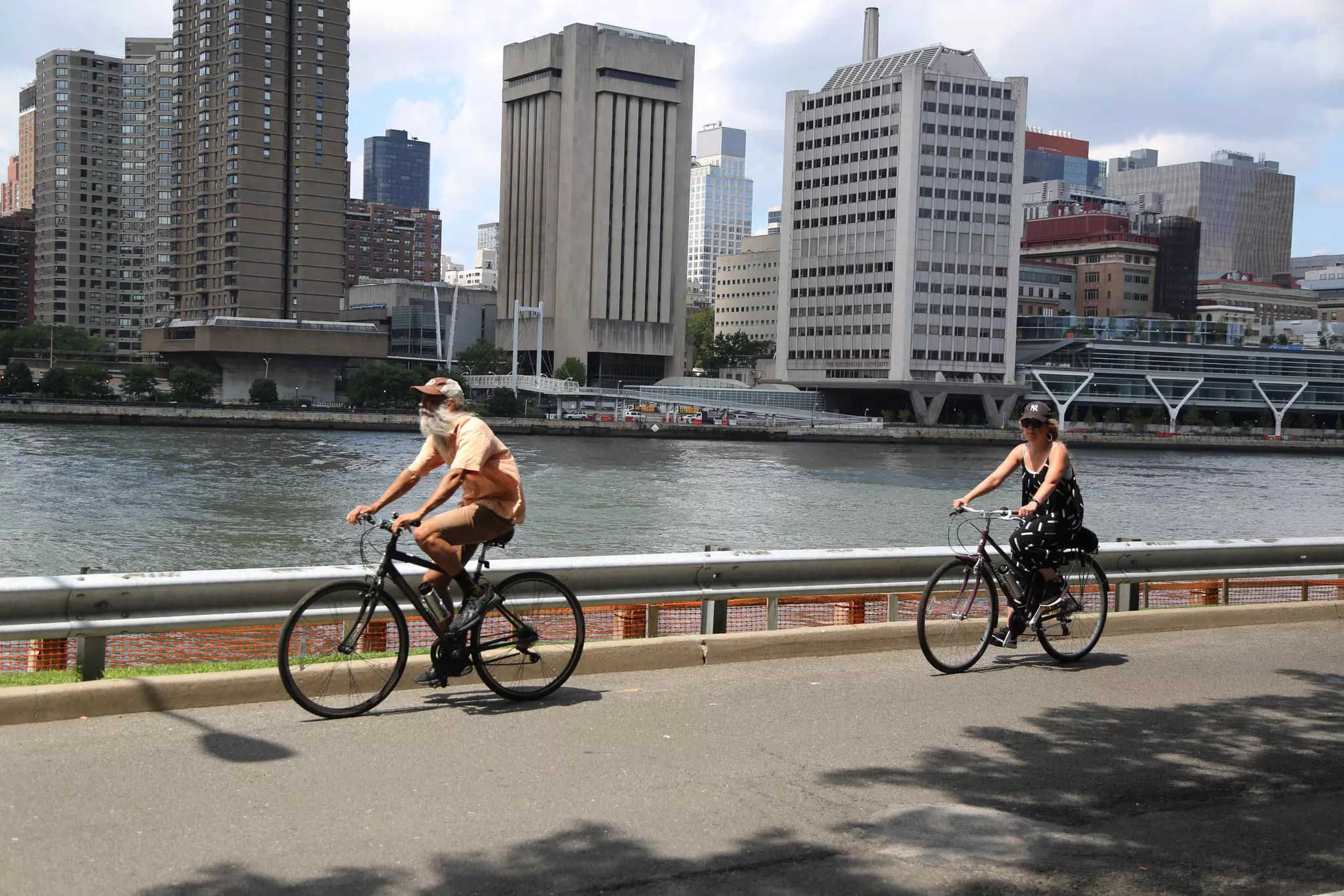 Bike riders cruising near the water on Roosevelt Island