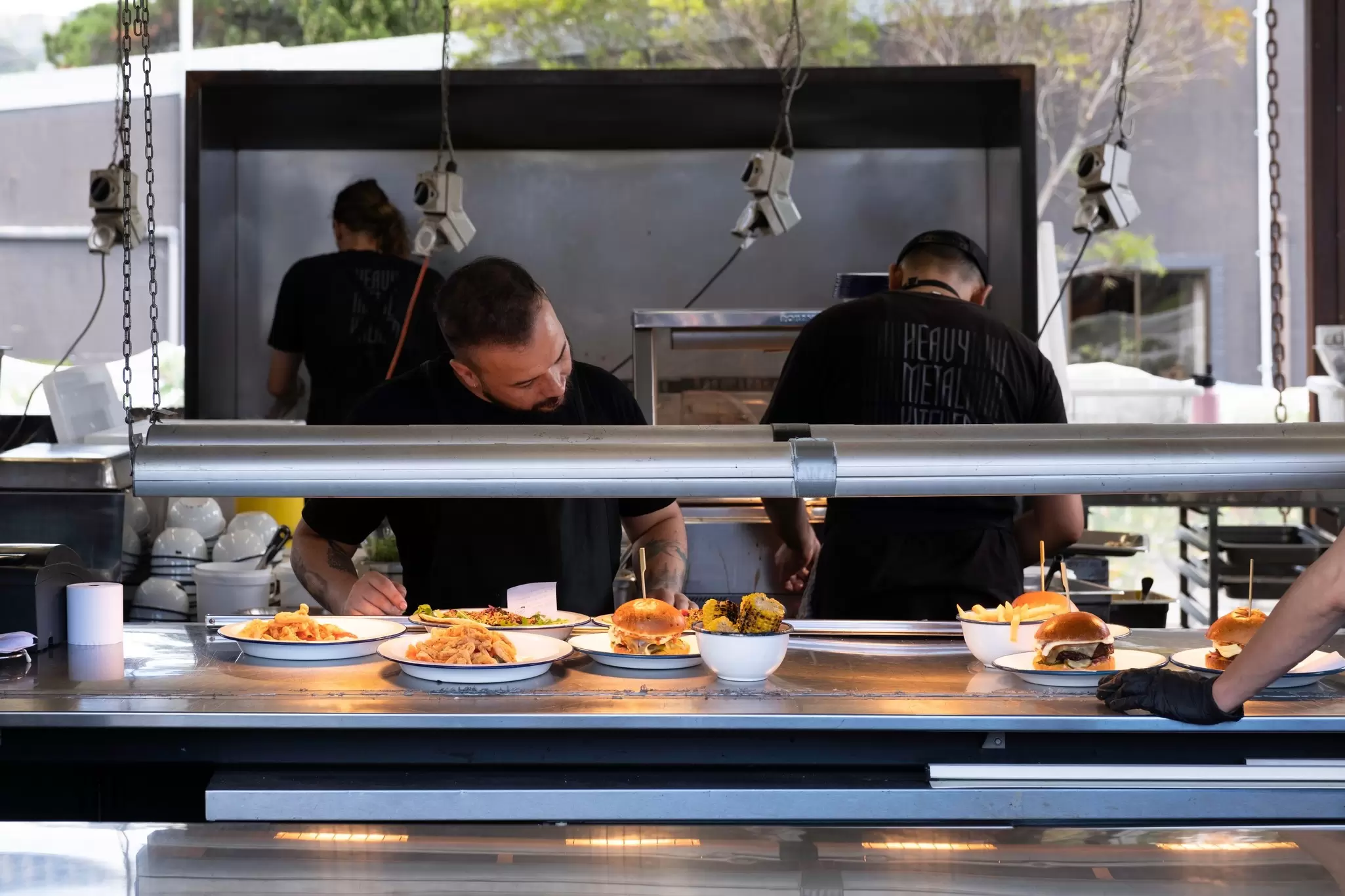 Chefs preparing food at an open-air kitchen in MONA Museum in Hobart, Tasmania.