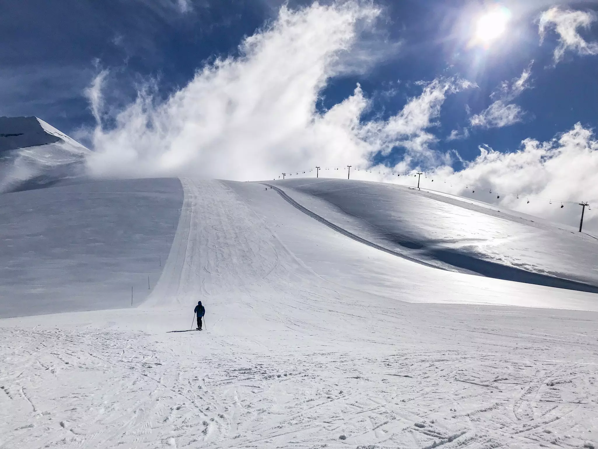 Man walks up hill near the ski station in Chile. Natalia Manczyk/Shutterstock