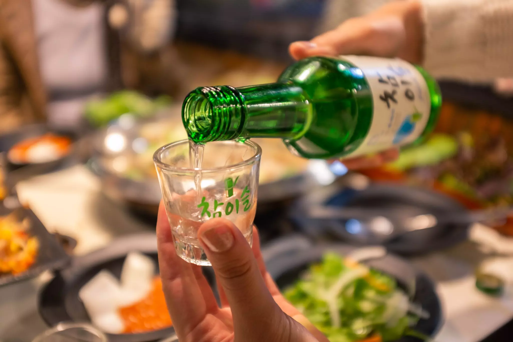 Pouring soju in glass