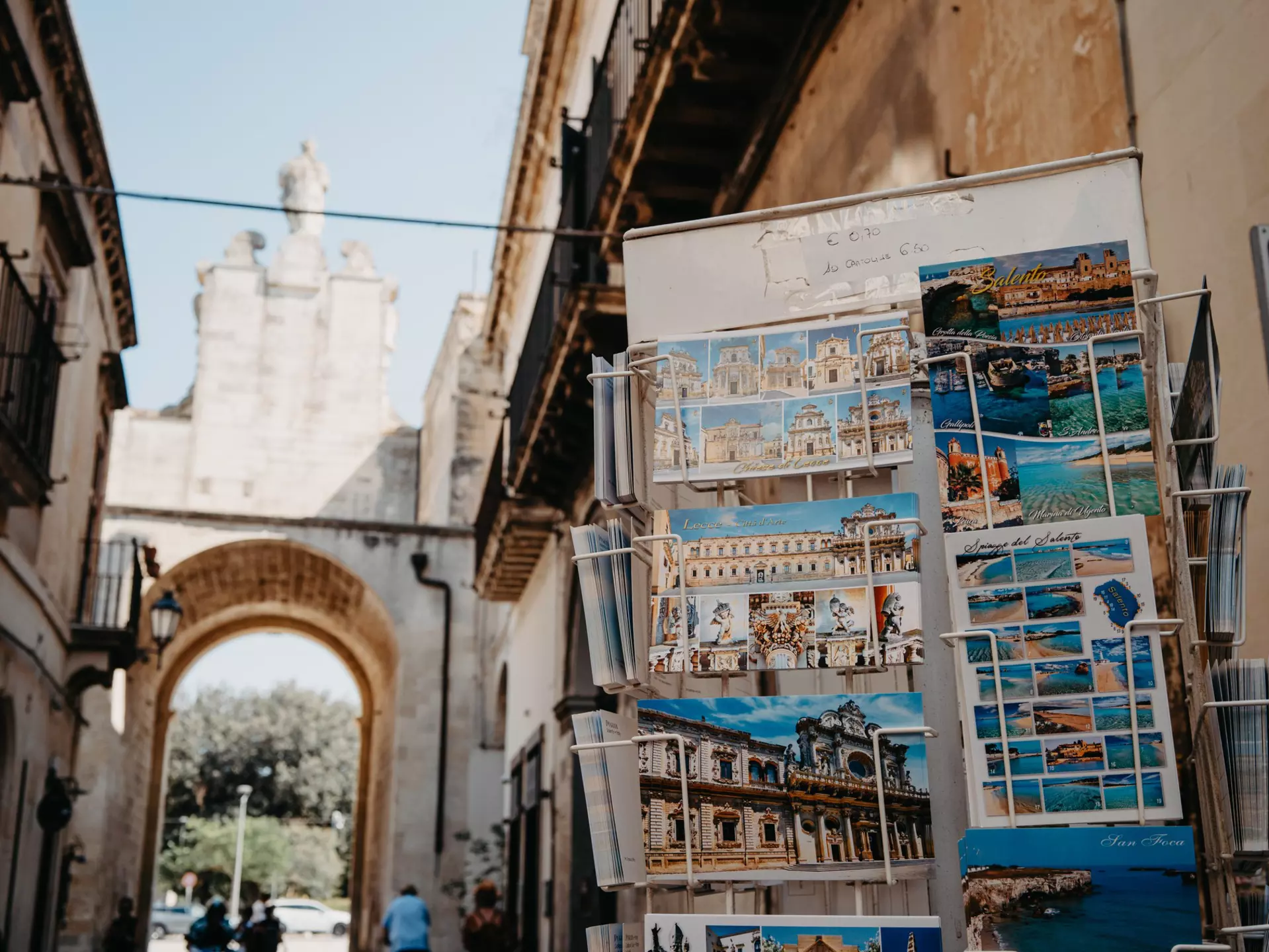 Porta San Biagio one of the gates of the old town with postcards on display for sale on the right
