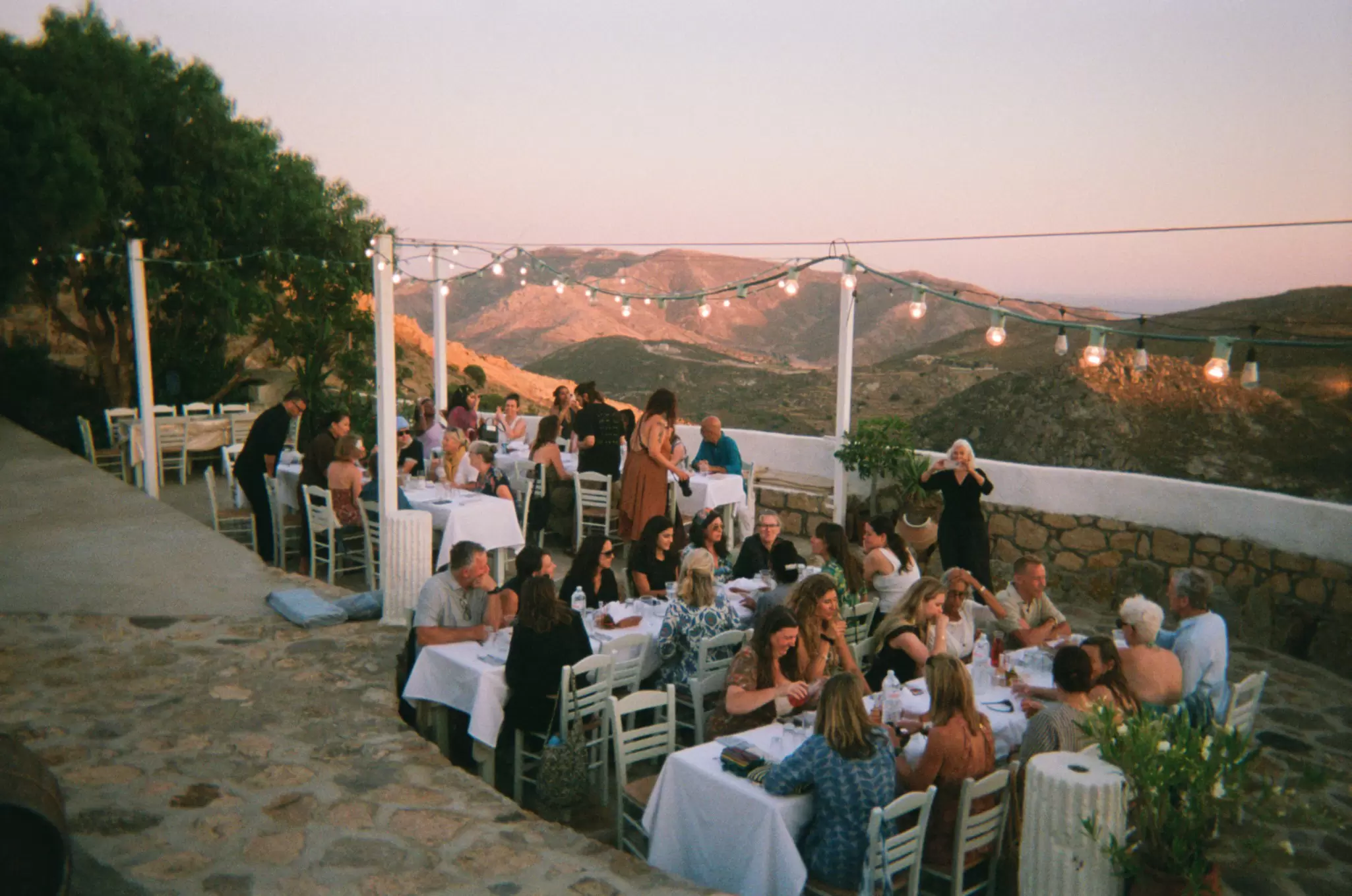People enjoying dinner outside in Greece.