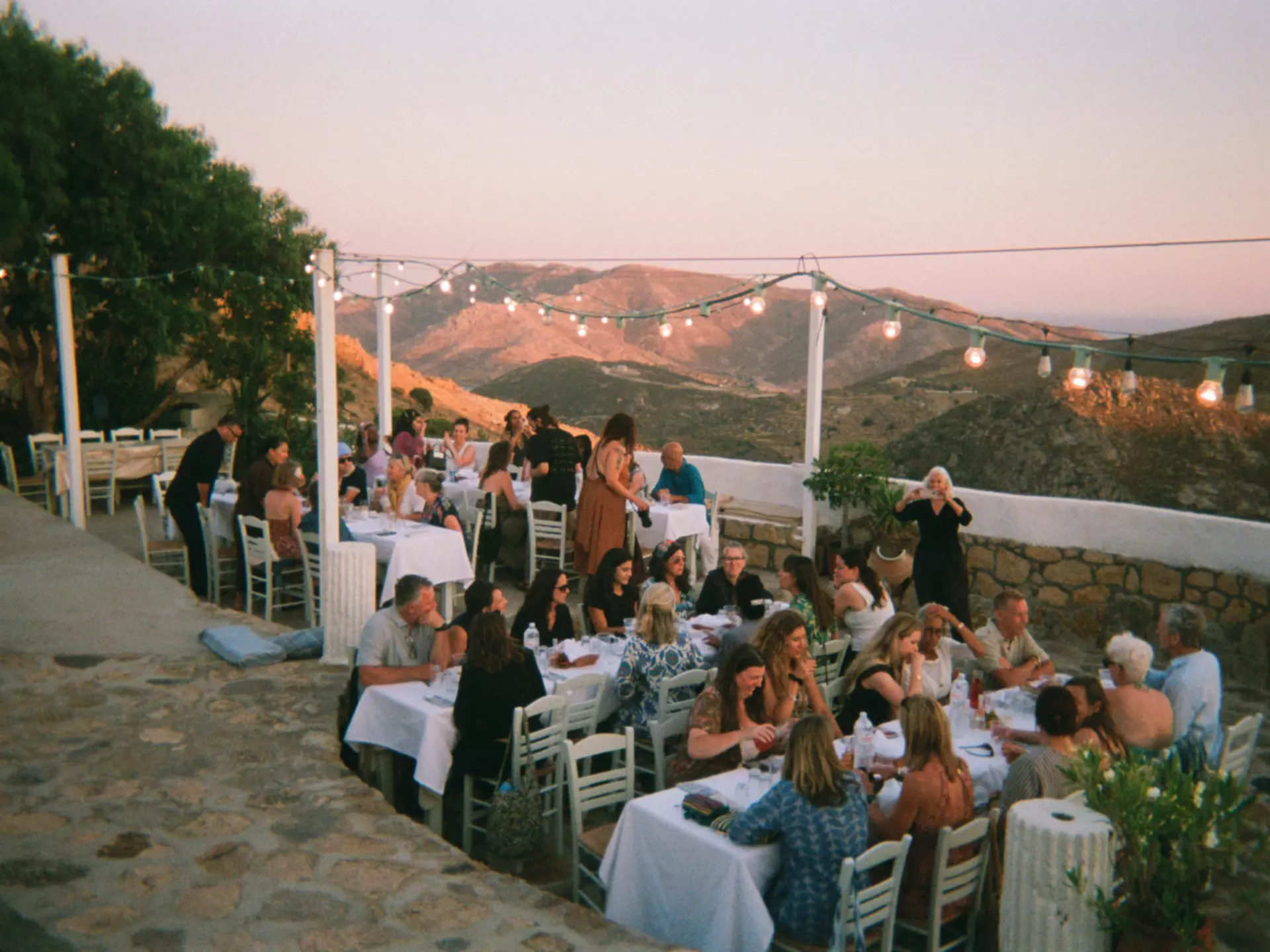 People enjoying dinner outside in Greece.