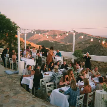 People enjoying dinner outside in Greece.