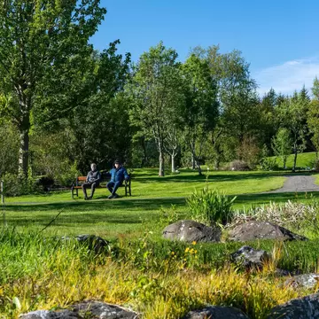 Couple resting in Reykjavik Botanical garden, Iceland. Date 2. June 2020