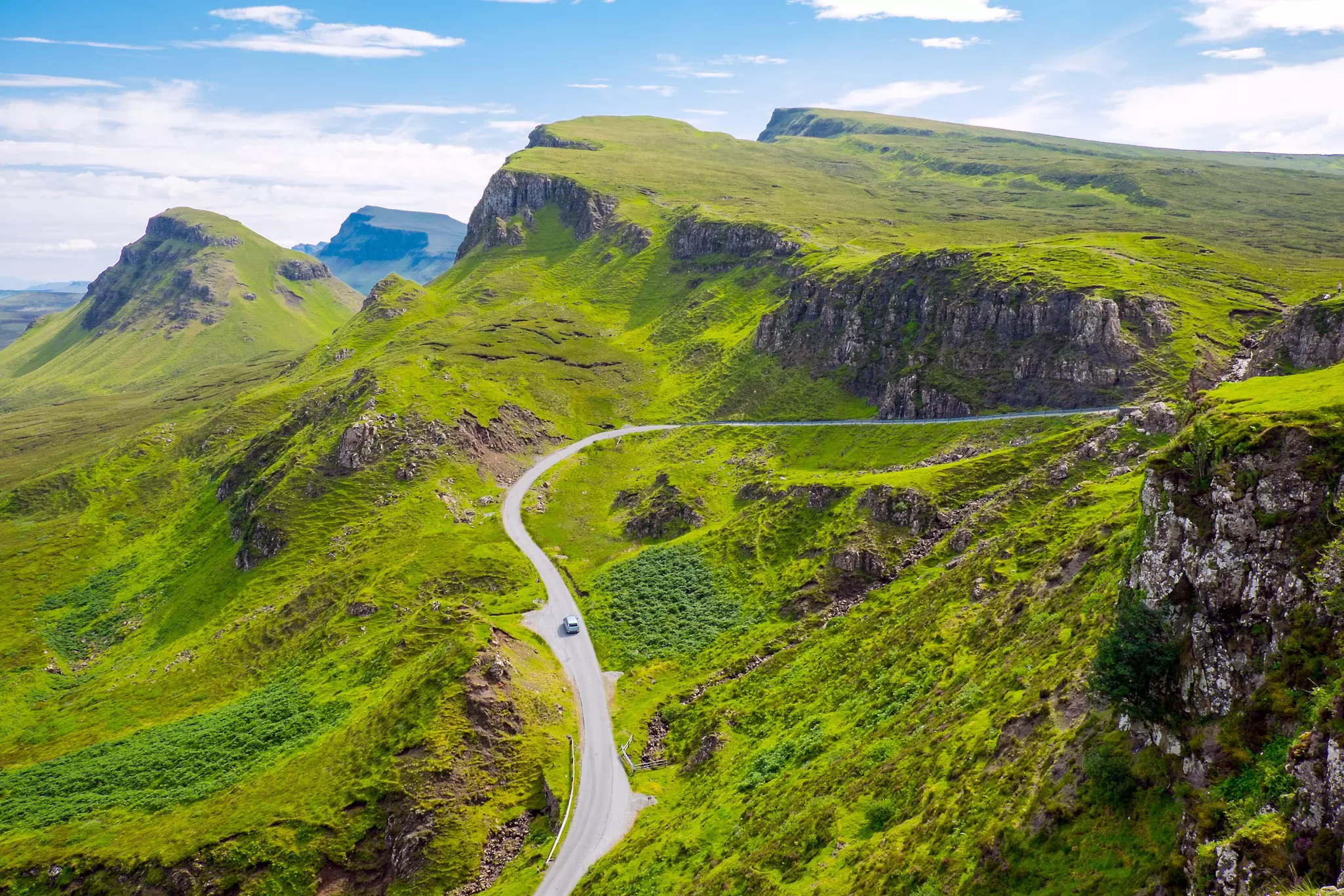 A road passes through a classic Scottish landscape on the Isle of Skye.