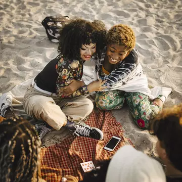 Sweden's long coastline means you're spoilt for choice when it comes to beaches
1350226885
beach, black woman, non binary person, braids, smiling, friends