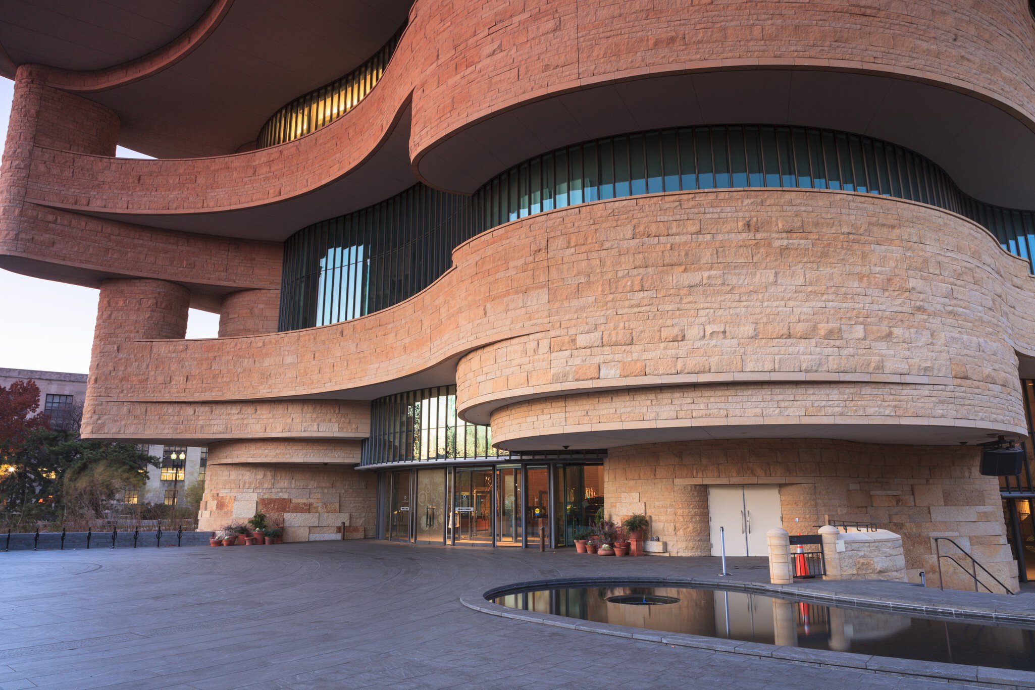 WASHINGTON, DC - NOVEMBER 30:  The entrance to the National Museum of the American Indian, as seen November 30, 2013, showcases the unusual curved architecture of the stone building.; Shutterstock ID 166031348; Your name (First / Last): Josh Vogel...