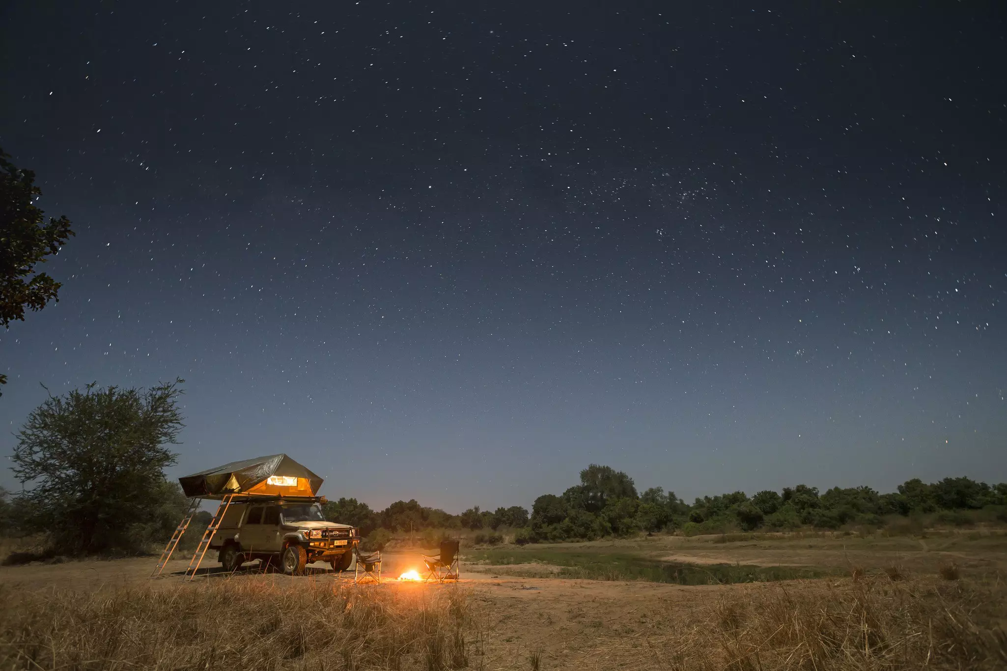 A clear night camping under the stars beside an oxbow lake at Kalovia campsite, close to one of the largest hippo populations in Africa