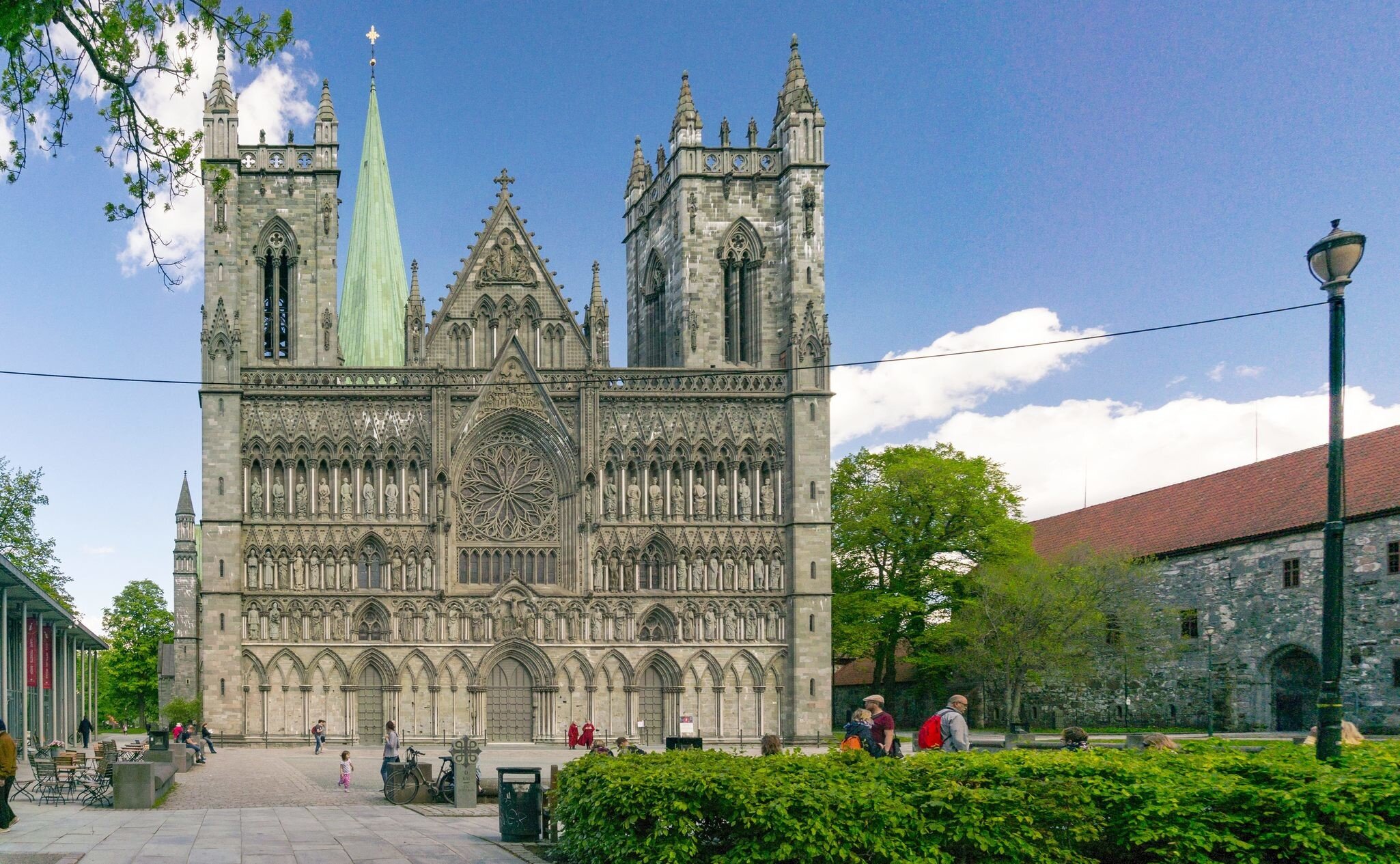 Trondheim, Norway - June 6, 2017:  View of the world's northernmost medieval cathedral national sanctuary of Norway, built over the grave of St. Olav. The sculptures and church in romanesque style; 
Nidaros Domkirke

Shutterstock ID 659296807; you...