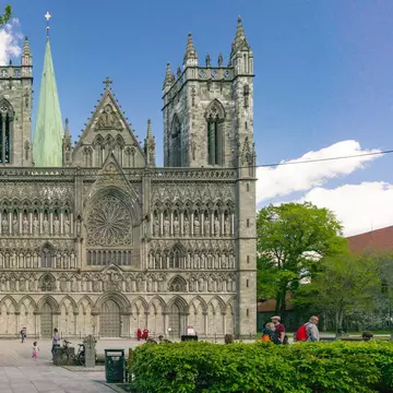 Trondheim, Norway - June 6, 2017:  View of the world's northernmost medieval cathedral national sanctuary of Norway, built over the grave of St. Olav. The sculptures and church in romanesque style; 
Nidaros Domkirke

Shutterstock ID 659296807; you...