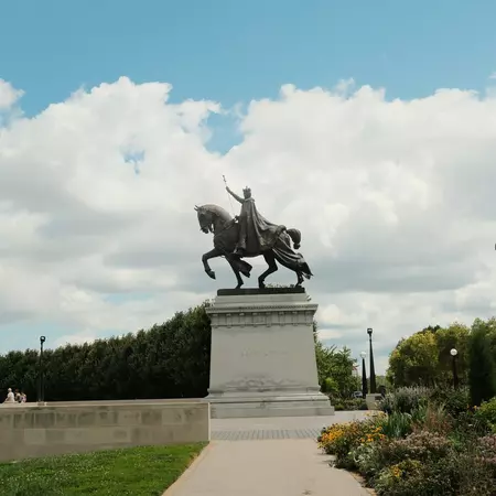 A large bronze statue of a man riding a horse
