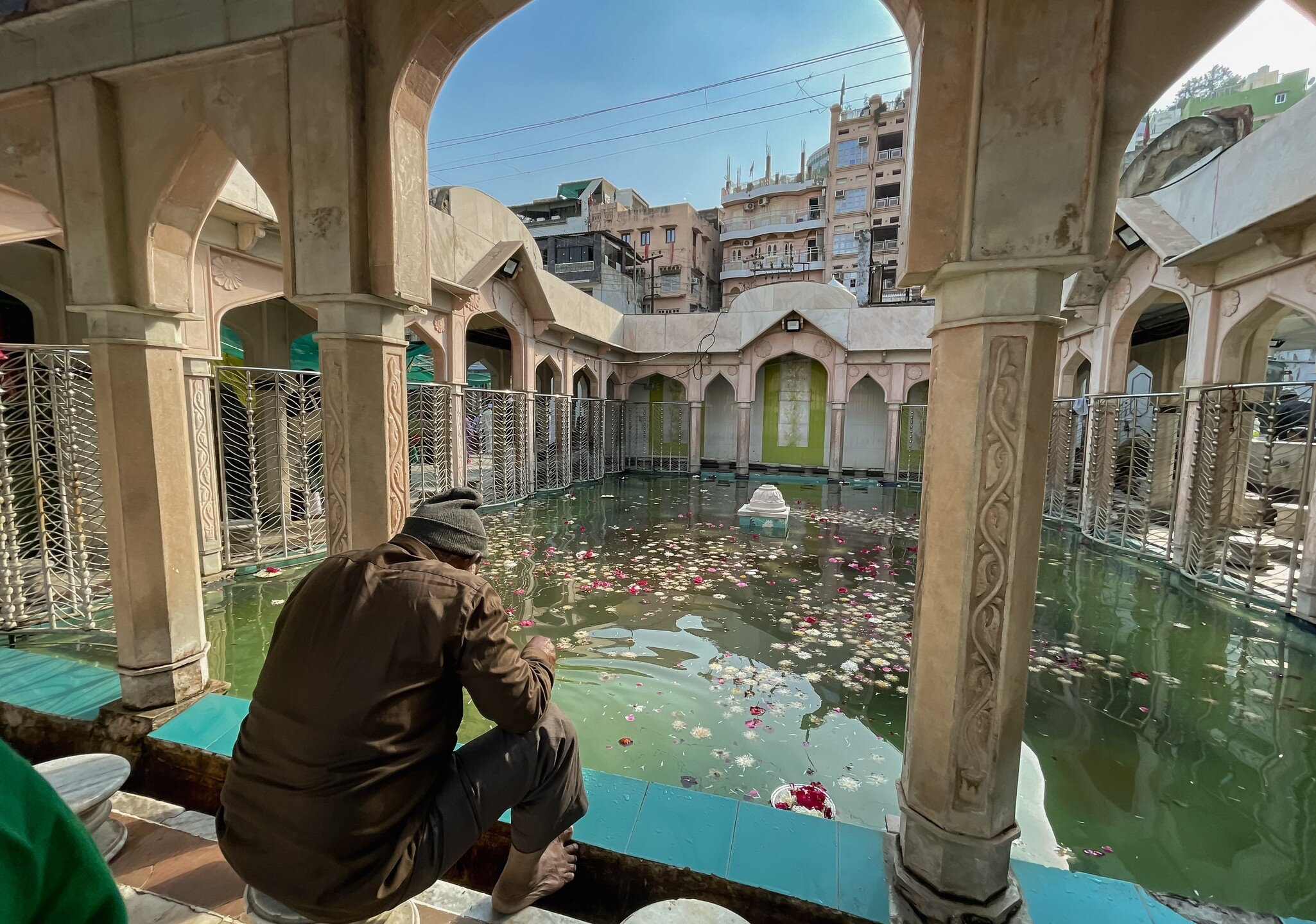 Man sitting in Hazrat Khwaja Moinuddin Chishty Dargah of Sufi saint at Ajmer, Rajasthan, India. 