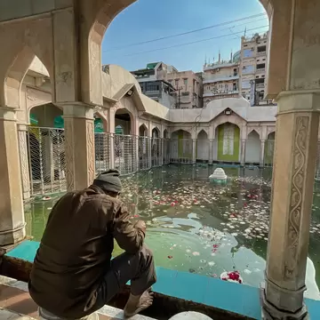 Man sitting in Hazrat Khwaja Moinuddin Chishty Dargah of Sufi saint at Ajmer, Rajasthan, India. 