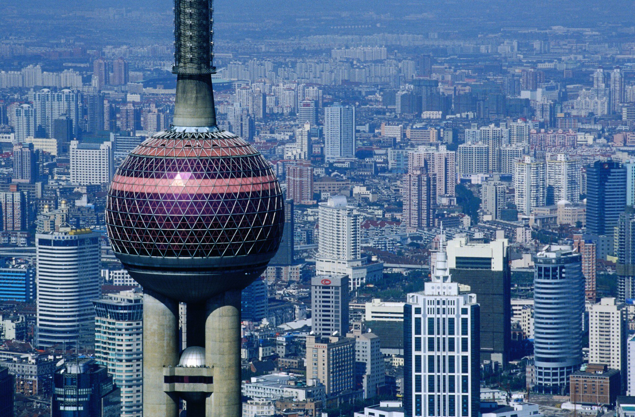 Aerial view of the Oriental Pearl TV Tower in Shanghai, China, with the city in the background.