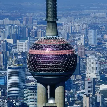 Aerial view of the Oriental Pearl TV Tower in Shanghai, China, with the city in the background.