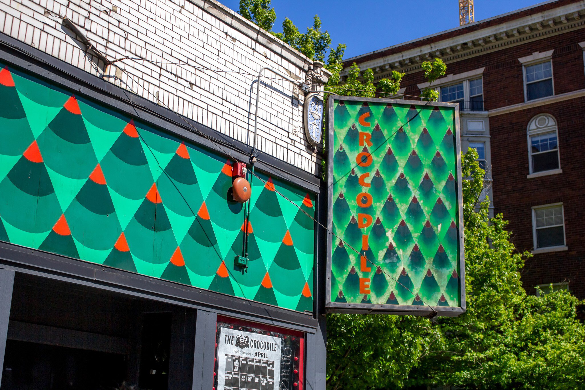 The exterior of a live music venues with a green patterned sign that says