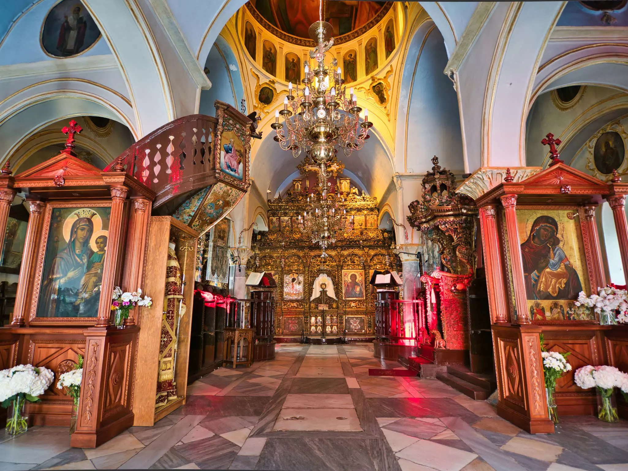 Interior of the Monastery of Panagia Tourliani with various sacred images and altars.