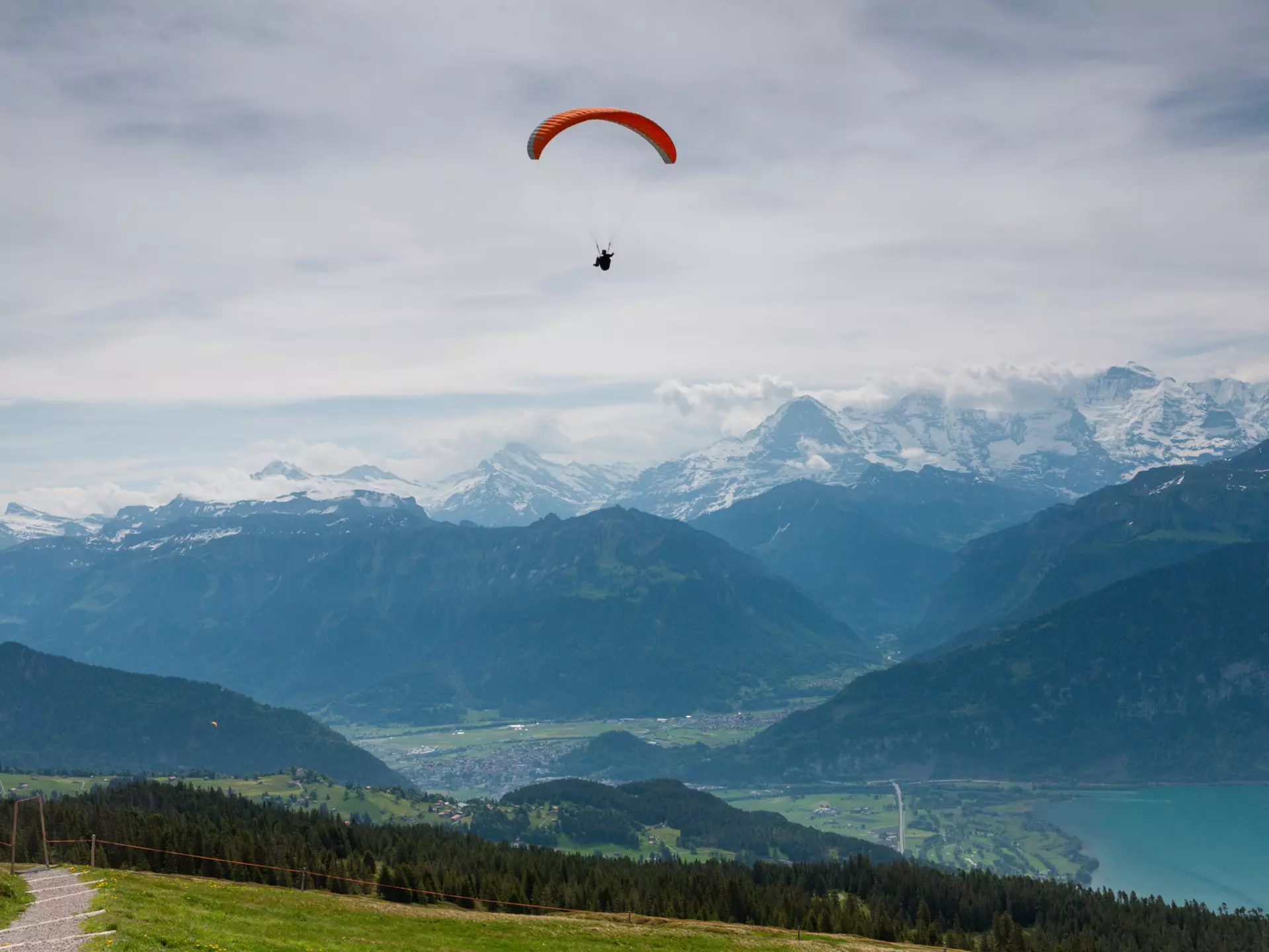 A hang glider sailing the skies above Interlaken, Switzerland. Jekaterina Nikitina / Getty Images