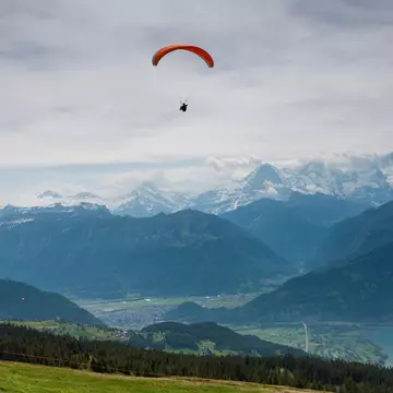 A hang glider sailing the skies above Interlaken, Switzerland. Jekaterina Nikitina / Getty Images