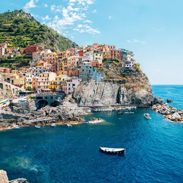 Seaside village Manarola, Colorful buildings and beach in Cinque Terre, Italy