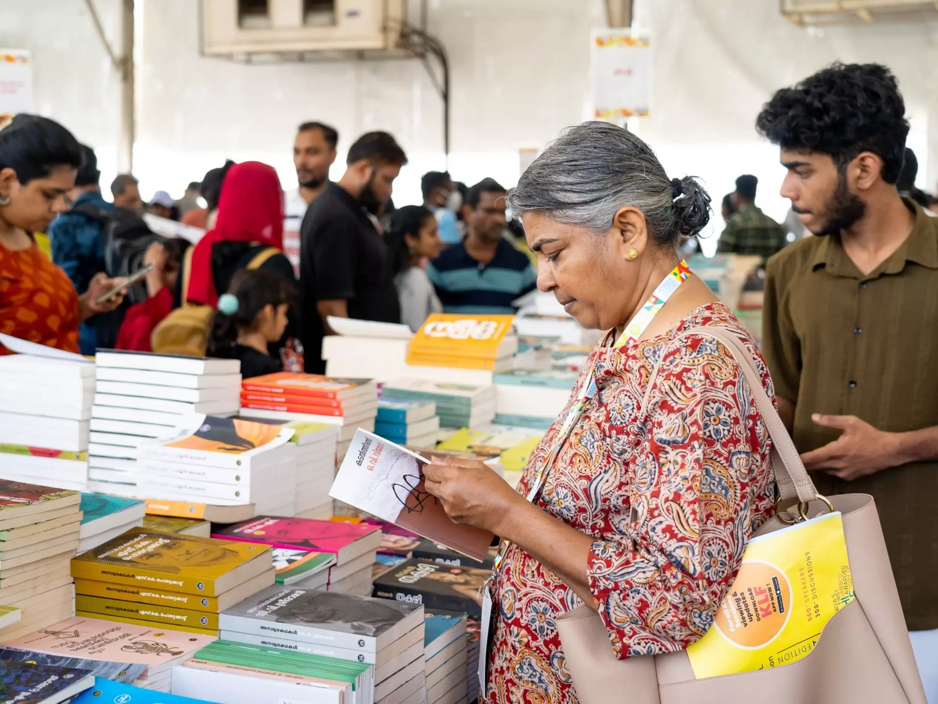 People browse at tables of books.